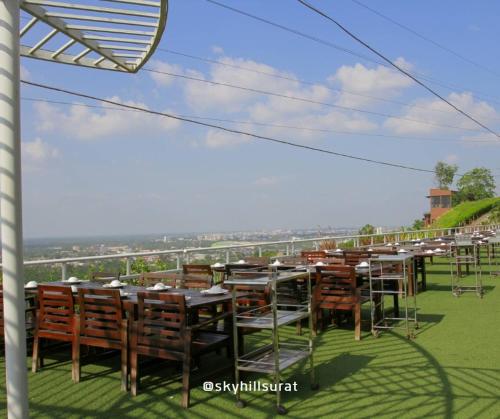 a group of tables and chairs on a roof at Sky View Luxury Pool Villa - SHA in Surat Thani