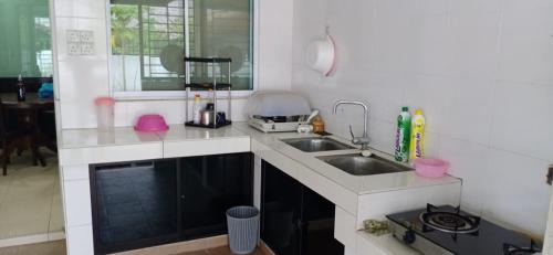 a kitchen with a sink and a counter top at Moyan Square By Natol Homestay in Kuching