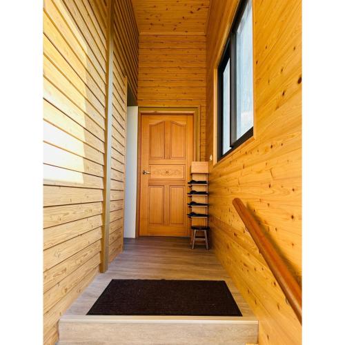 a hallway with a wooden door and a window at 星森林包棟住宿-台中東勢-山區景觀 in Dongshi