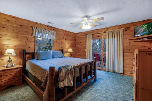 a bedroom with a bed and a ceiling fan at Peaceful Living Minutes from Blue Ridge hot tub pool table in Blue Ridge