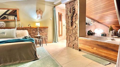 a large bathroom with a tub and a sink at Château de feuilles & SPA - Praslin island in Baie Sainte Anne