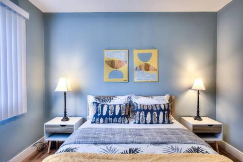 a bedroom with a bed with blue walls and two lamps at Charming 2BR with Balcony in Montreal in Montreal