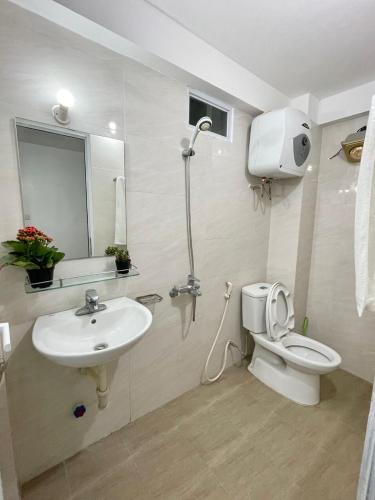 a bathroom with a toilet and a sink and a shower at The little Ha Noi in Hanoi
