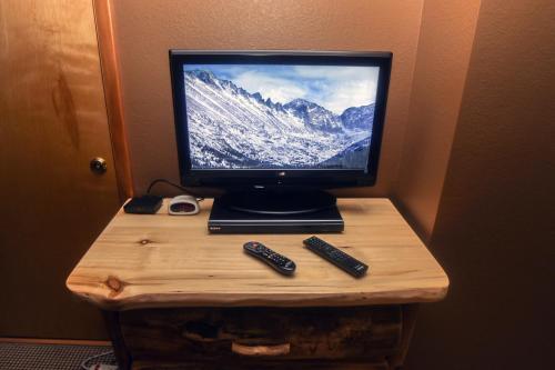 A television and/or entertainment centre at Timber Creek Chalets- 2A chalet