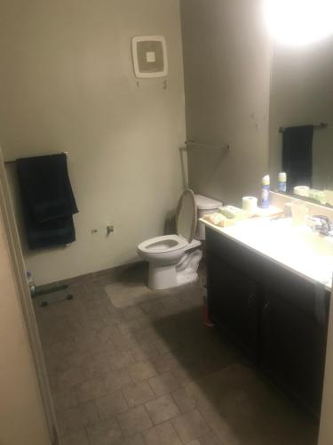 a bathroom with a toilet and a sink at Penn Square Apts in Baltimore