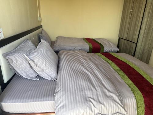 two beds sitting next to each other in a bedroom at Kankali Viewpoint Resort Pvt Ltd in Kathmandu