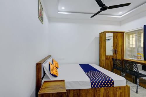 a bedroom with a bed and a desk at Hotel Aqua Palace Inn in Kannur
