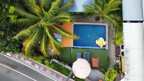 an overhead view of a house with a pool and a palm tree at At Thara Aonang in Ao Nang Beach