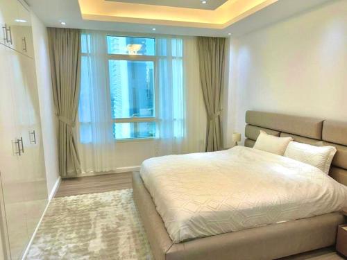 a bedroom with a large bed and a window at Marina Bliss: Stunning Views, By Marina Walk & JBR in Dubai
