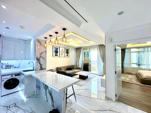 a kitchen and living room with a couch and a table at Marina Bliss: Stunning Views, By Marina Walk & JBR in Dubai