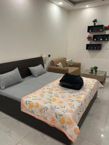 a bedroom with a bed with a blanket on it at Hello studio in Noida