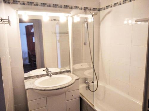 a white bathroom with a sink and a shower at Résidence Pic Du Midi - Apt n°41 - 1er étage - Bâtiment Campan2 MAE-8604 in La Mongie
