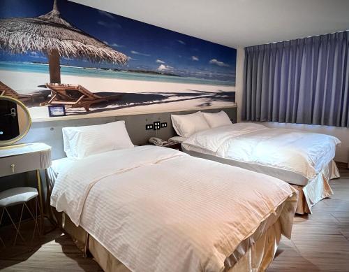 two beds in a hotel room with a painting on the wall at Good Time Boutique Hotel in Kaohsiung