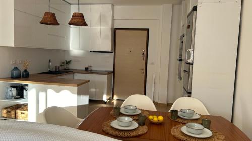 cocina y comedor con mesa y sillas en Casa con vista mare en Vlorë