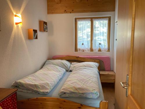 RosswaldにあるChalet Lalulaのベッドルーム1室(ベッド2台、窓付)