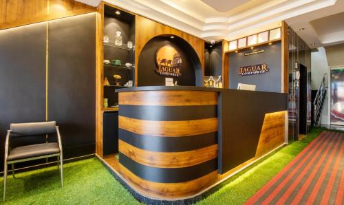 a bar in a dressing room with a chair at Treebo Jaguar Comforts, 3 Kms From Mahatma Gandhi Park in Chikmagalūr