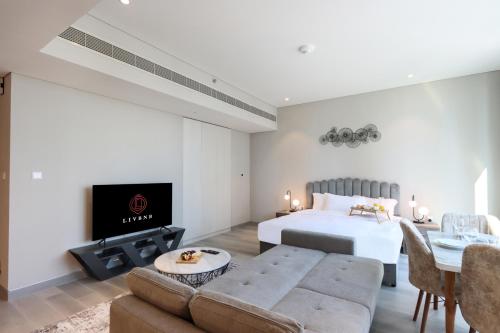 a bedroom with a bed and a living room at Livbnb -Glam Studio in Marina, Next to Marina Walk in Dubai