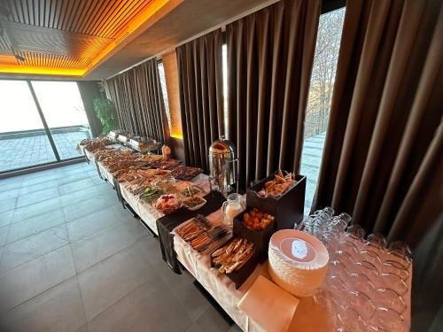 a row of buffet tables with food on them at Mamababa FREE SPA & Wellness Kopaonik in Kopaonik