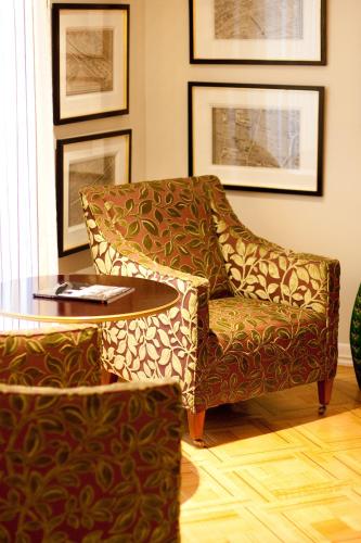 a living room with a chair and a table at Hotel Boutique Le Reve in Santiago