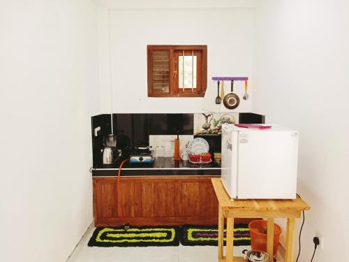 a kitchen with a counter and a white refrigerator at New Summer Vacation in Hikkaduwa