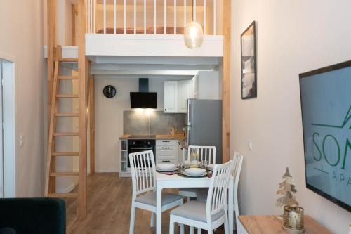a small kitchen and dining room with a loft bed at Apartament Sommet Ostoja Parku Narodowego in Szklarska Poręba