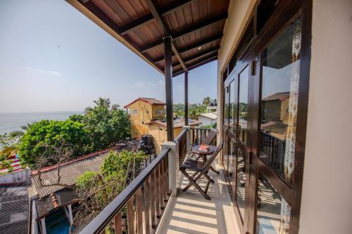 a balcony with a view of the ocean at The Waves Unawatuna in Unawatuna