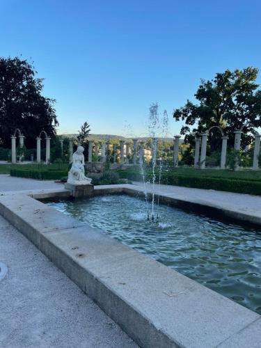 a fountain with a statue in a park at Hotel Berg in Stuttgart