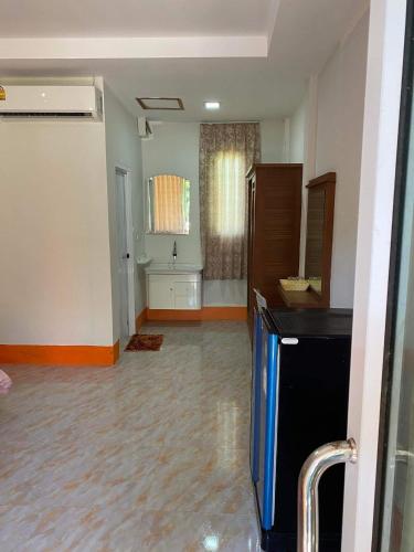 an empty room with a kitchen and a living room at Lanta Paradise Beach Resort in Ko Lanta