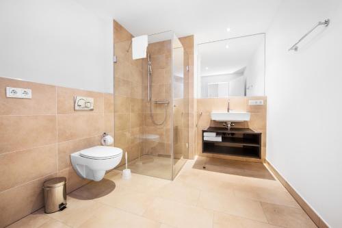 a bathroom with a shower and a toilet and a sink at Livingroom Bad Homburg Boardinghouse in Bad Homburg vor der Höhe