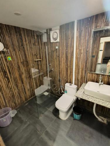 a bathroom with a toilet and a sink at Aqua Beach Rooms, only accommodation on Ashwem Beach in Mandrem