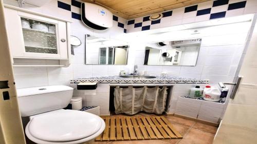 a small bathroom with a toilet and a sink at Résidence Valgardena - Appartements pour 4 Personnes 471 in Puy-Saint-Vincent