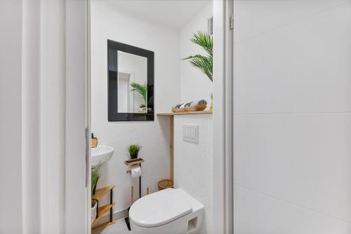 a bathroom with a white toilet and a sink at NEU: Stylische Suite mit Ausblick in Sindelfingen