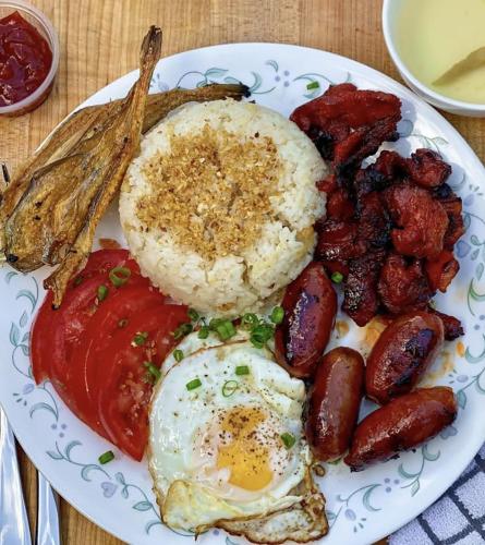 a plate of breakfast food with eggs sausage and beans at Aquaventure Reef Club in Mabini