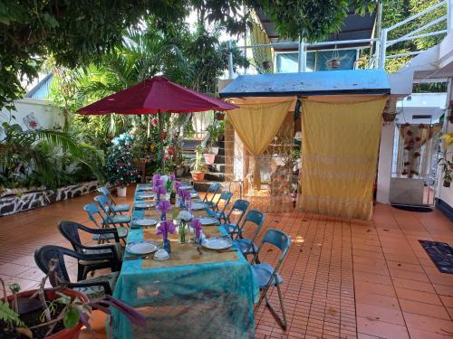 a long table set up for a party in a courtyard at Open Air Café & Apartments in Port Louis