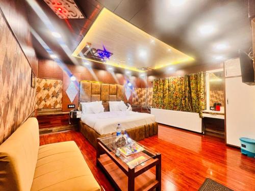 a hotel room with a bed and a table at Pine View Resort in Gulmarg