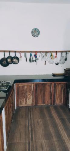 a kitchen with wooden cabinets and cooking utensils at Magnolia Hideout in Nuwara Eliya