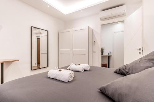 a bedroom with a large bed with two towels on it at LoungeFloor Metro A Netflix & Wi-Fi in Rome