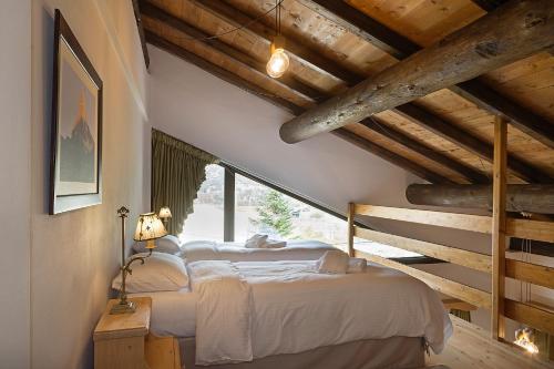 a bedroom with two beds and a large window at Alpine Aria in Kalavrita