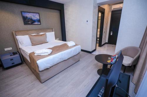 a hotel room with a bed and a small table at Arium Hotel Baku in Baku