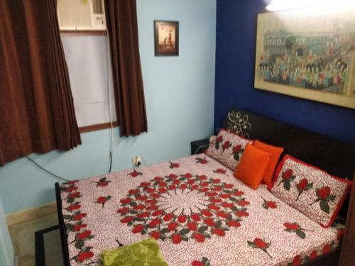 a bedroom with a bed with a quilt on it at Deer park Studio Flat (1 BHK) in New Delhi