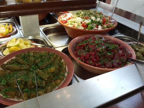 three bowls of food on top of a counter at Meropi Hotel & Apartments in Malia