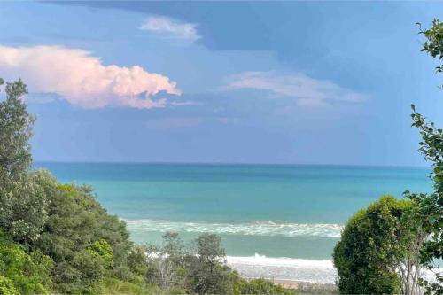 a view of the ocean from a bluff at The Dunes *Beachfront* Lake Tyers Beach in Lake Tyers