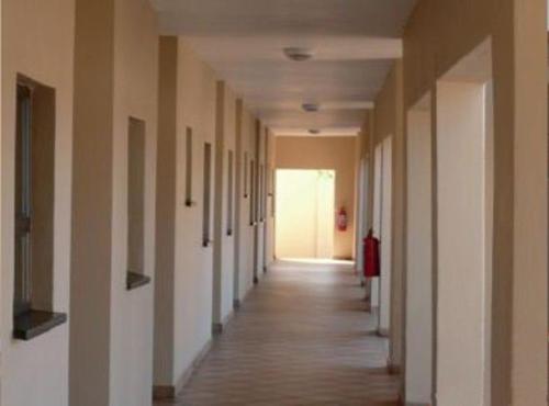 un pasillo vacío de un edificio de oficinas con un largo pasillo en DZUVHA VILLAGE INN, en Thohoyandou