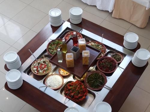 a table with many different types of food on it at Meropi Hotel & Apartments in Malia