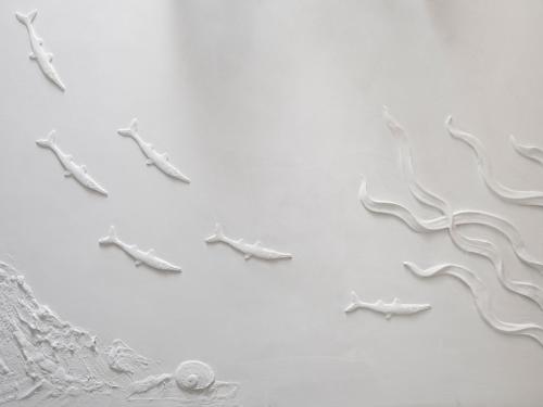 a white clock on a white wall at Villa Roma Imperiale in Forte dei Marmi