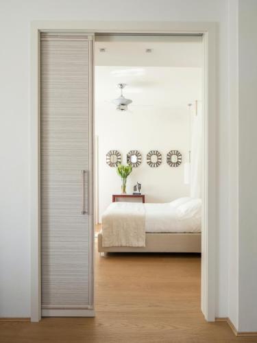 a bedroom with a door leading to a bed at Villa Roma Imperiale in Forte dei Marmi