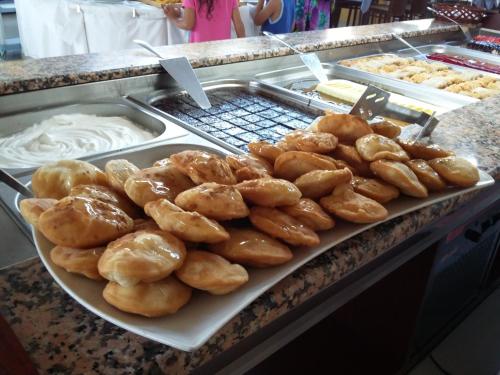 a tray of donuts on a counter in a bakery at Meropi Hotel & Apartments in Malia