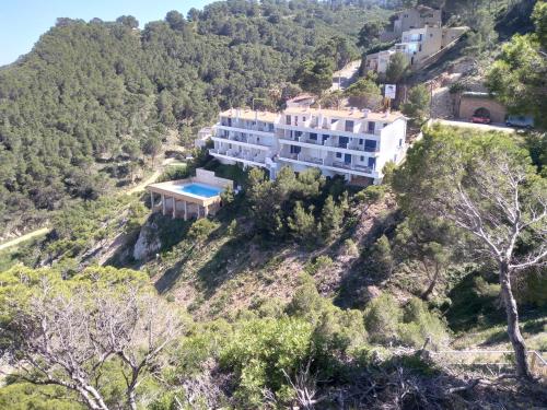 a house on the side of a mountain at "Belvédère de la Mer" Résidence "Icaros" Wifi-Piscine-Pkg in Begur