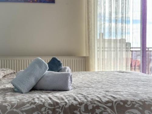 a stuffed animal sitting on top of a bed at Bluesky Apartment AXD in Alexandroupoli