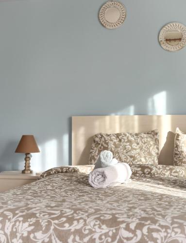 a bed with a towel and a stuffed animal on it at Bluesky Apartment AXD in Alexandroupoli
